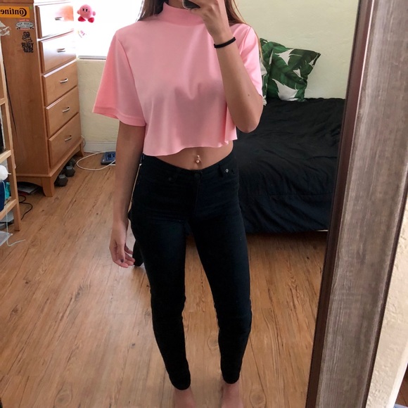 baby pink top and black jeans